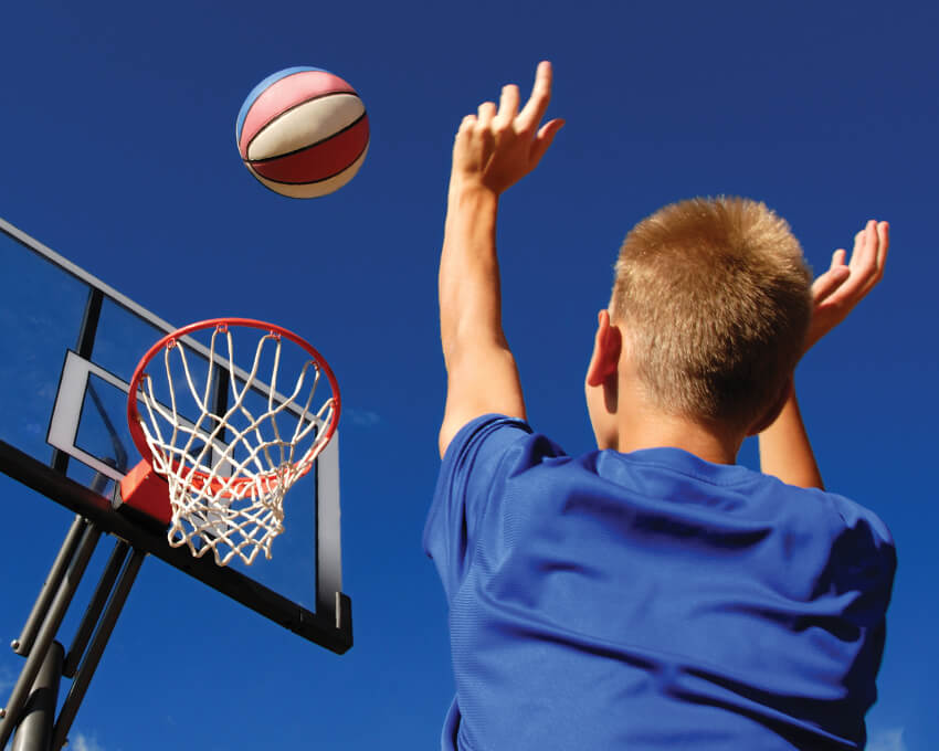 Teen throwing a basketball