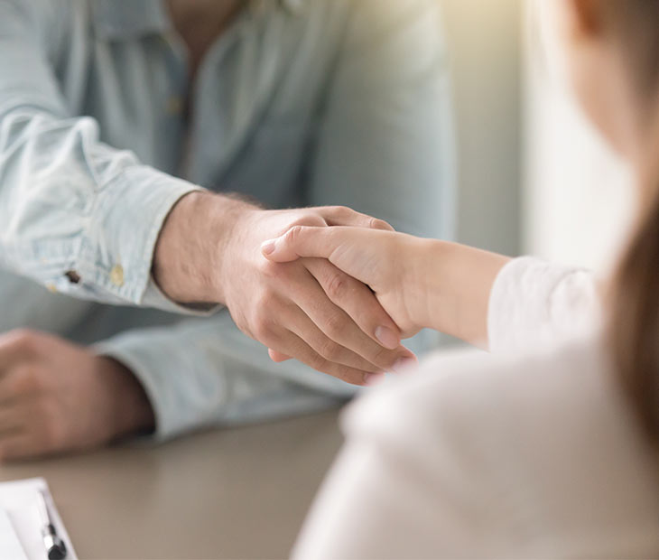 woman and man shaking hands