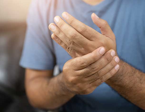 man holding wrist in pain