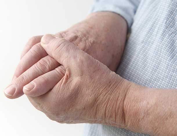 man suffering from hand stiffness