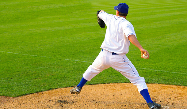 Baseball pitcher throwing pitch on the mound