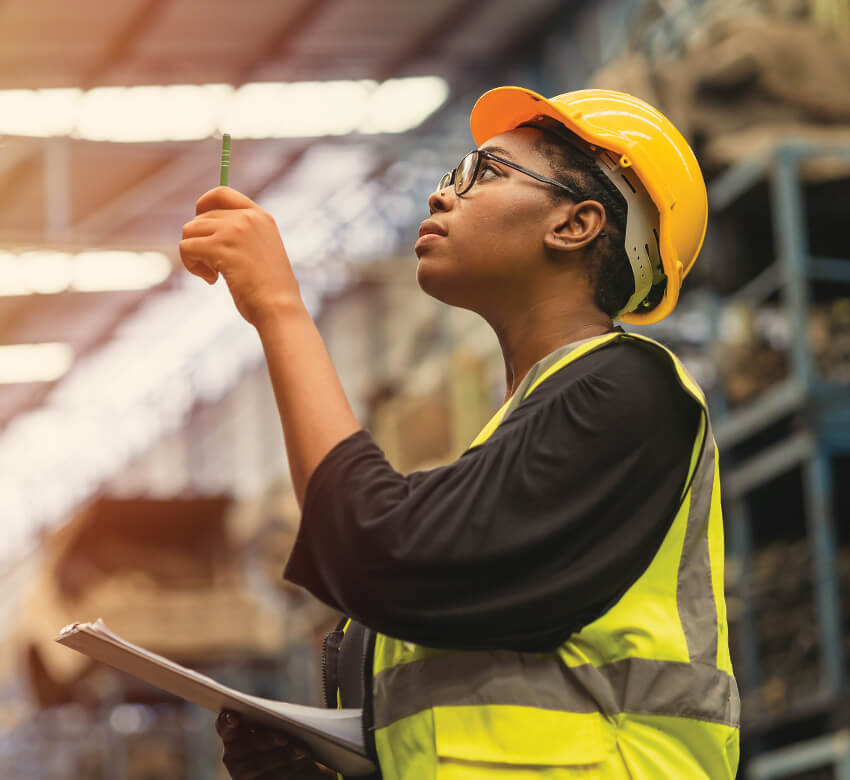 Woman managing stock in a warehouse